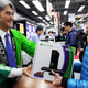 Pictured is a customer receiving an Xbox 360 at a Tokyo retailer.